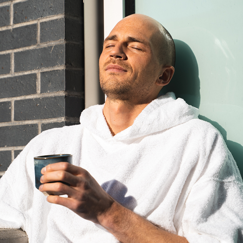 Man relaxing in the sun. Relax and feel good at Ritual Nordic Spa