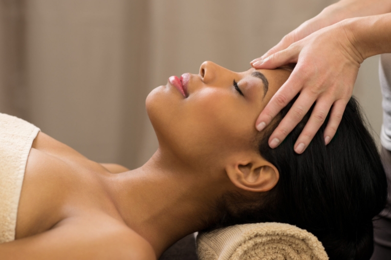 A woman receiving a gentle Swedish head massage. Swedish Massage at Ritual Nordic Spa in Downtown Victoria, BC