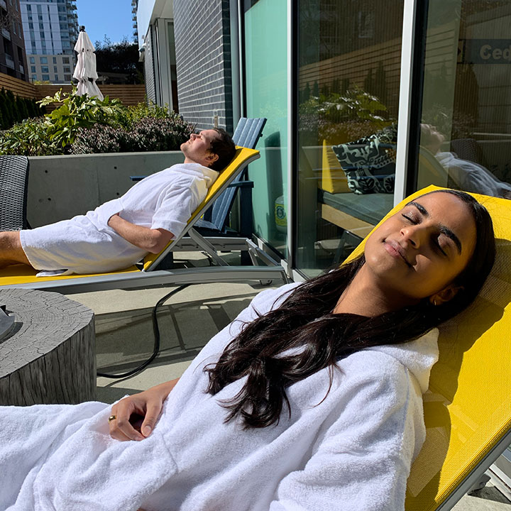 Woman sun bathing on the Patio at Ritual Nordic Spa in Victoria, British Columbia